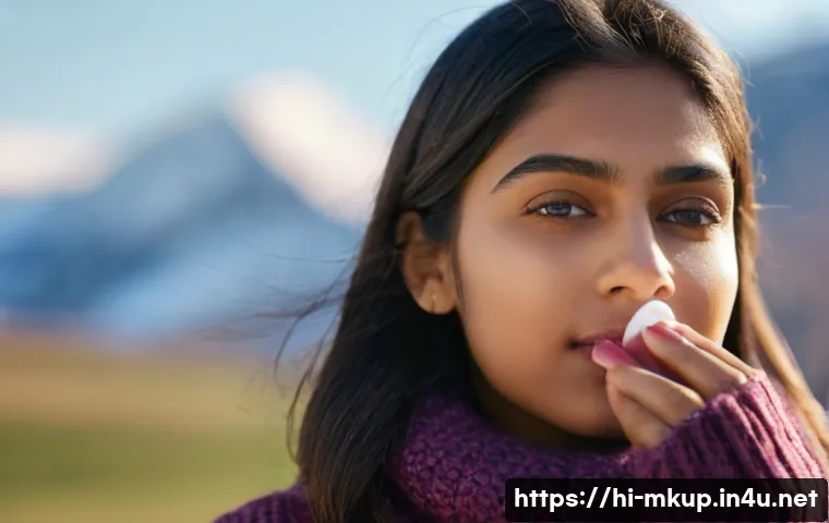 립 틴트와 립밤의 차이점 - A close-up portrait of a young Indian woman applying moisturizing lip balm outdoors on a cool, sunny...